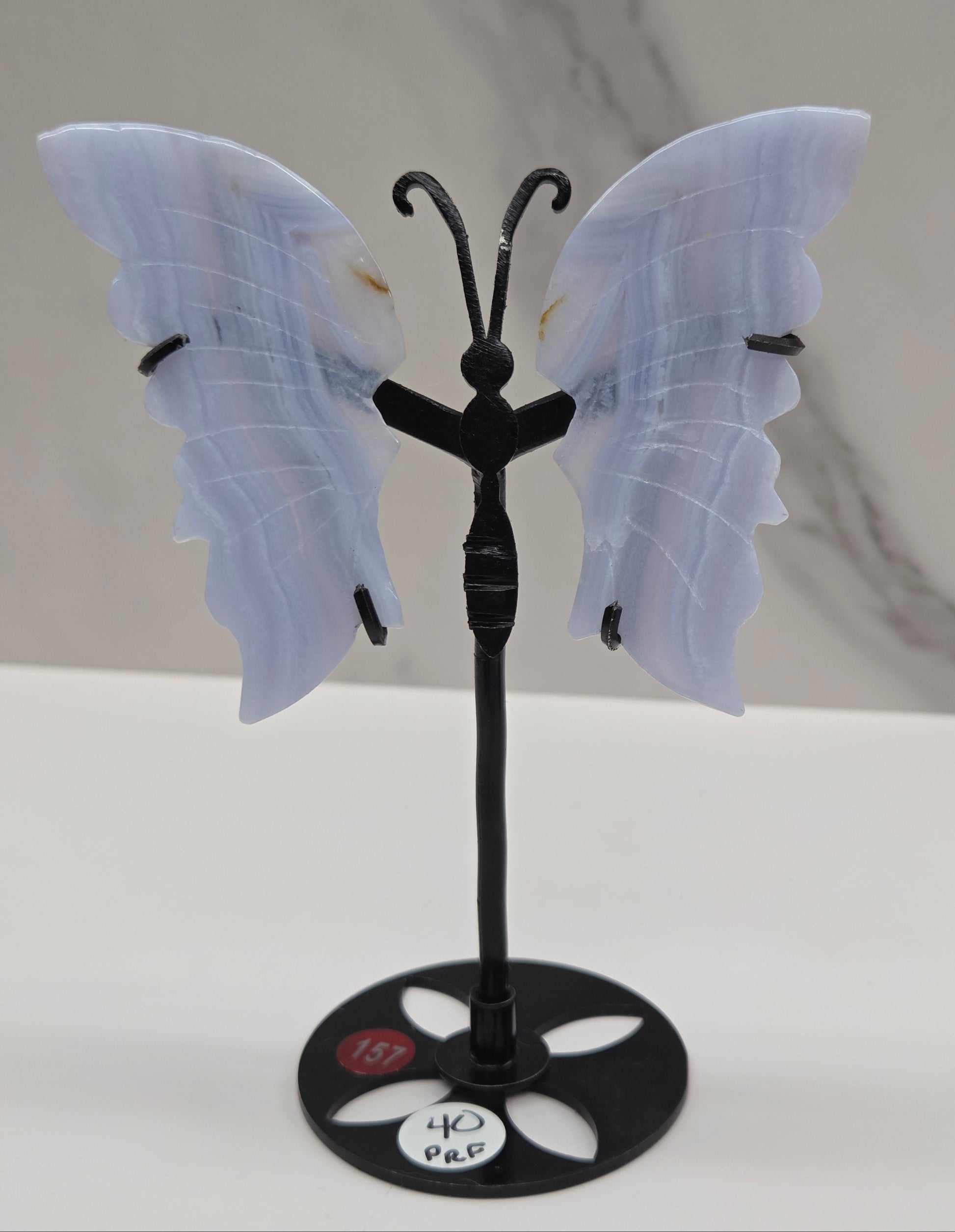 Blue Lace Agate butterfly figurines on stands with light blue wings and black bodies 