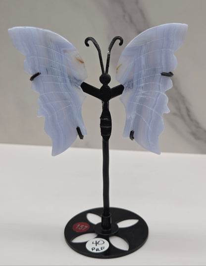 Blue Lace Agate butterfly figurines on stands with light blue wings and black bodies 