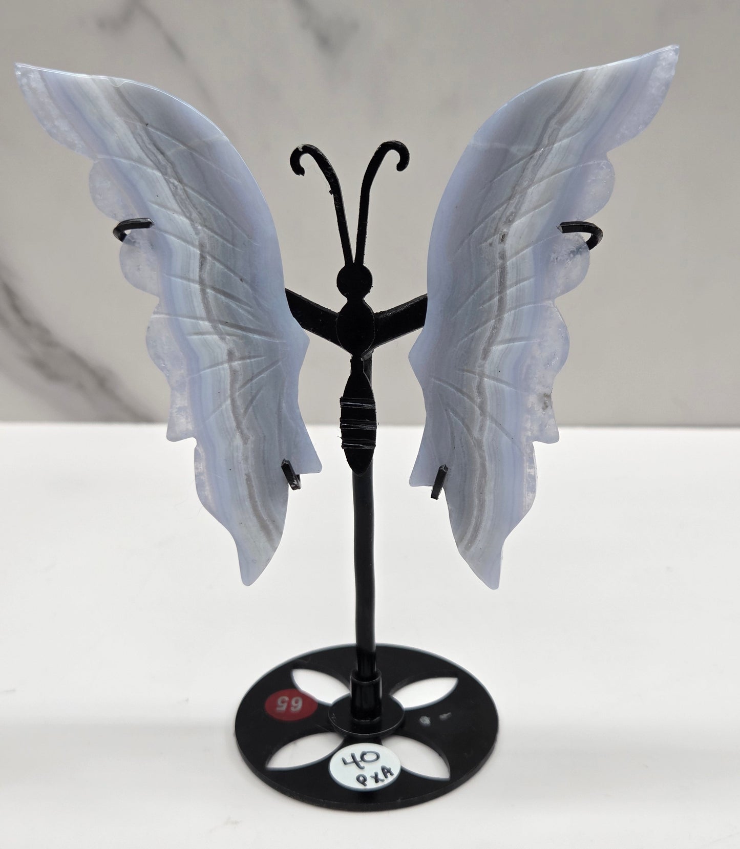 Blue Lace Agate butterfly figurines on stands with light blue wings and black bodies 