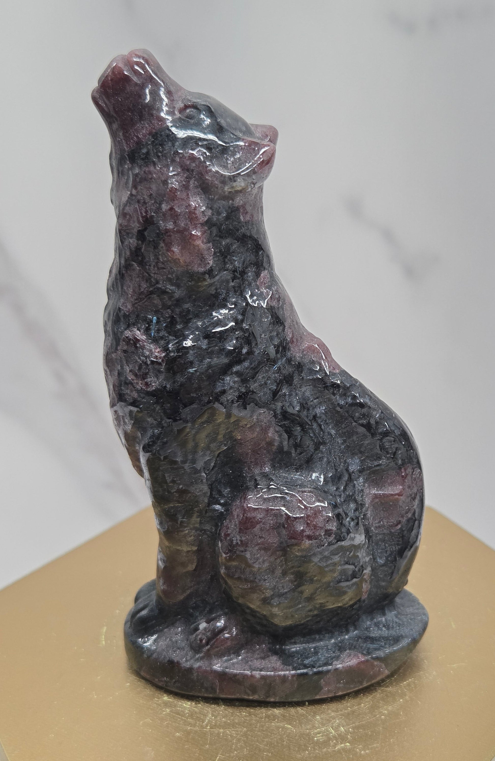 Garnet wolf carving on a neutral background