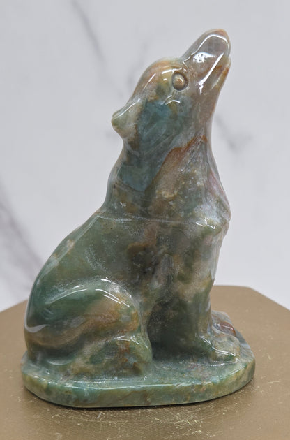 Ocean Jasper wolf carving on a neutral background