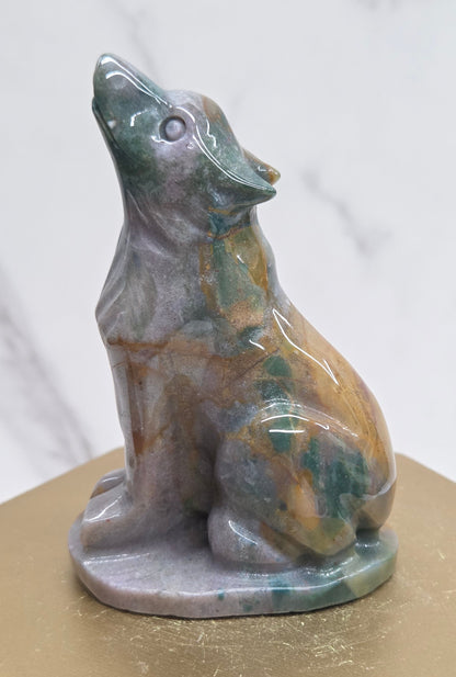 Ocean Jasper wolf carving on a neutral background