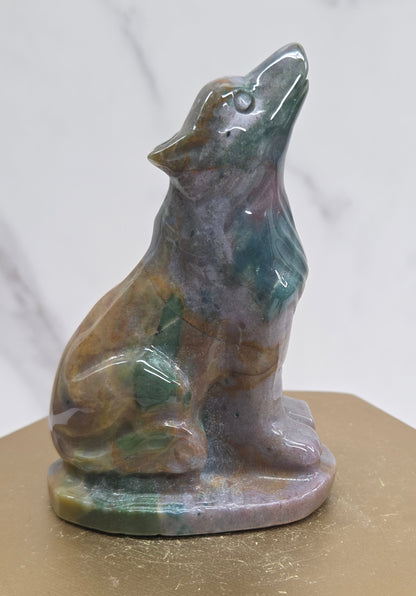 Ocean Jasper wolf carving on a neutral background