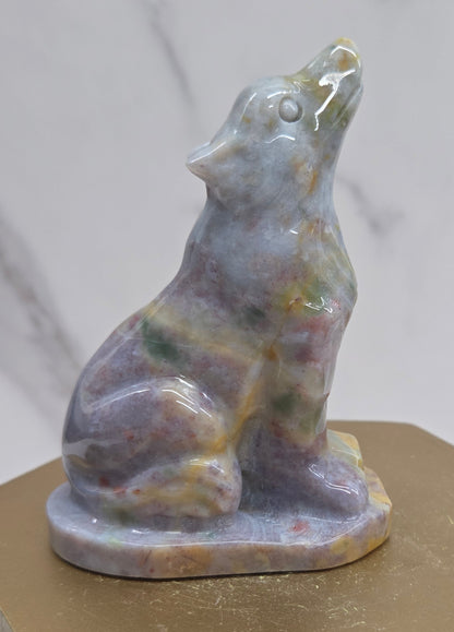 Ocean Jasper wolf carving on a neutral background