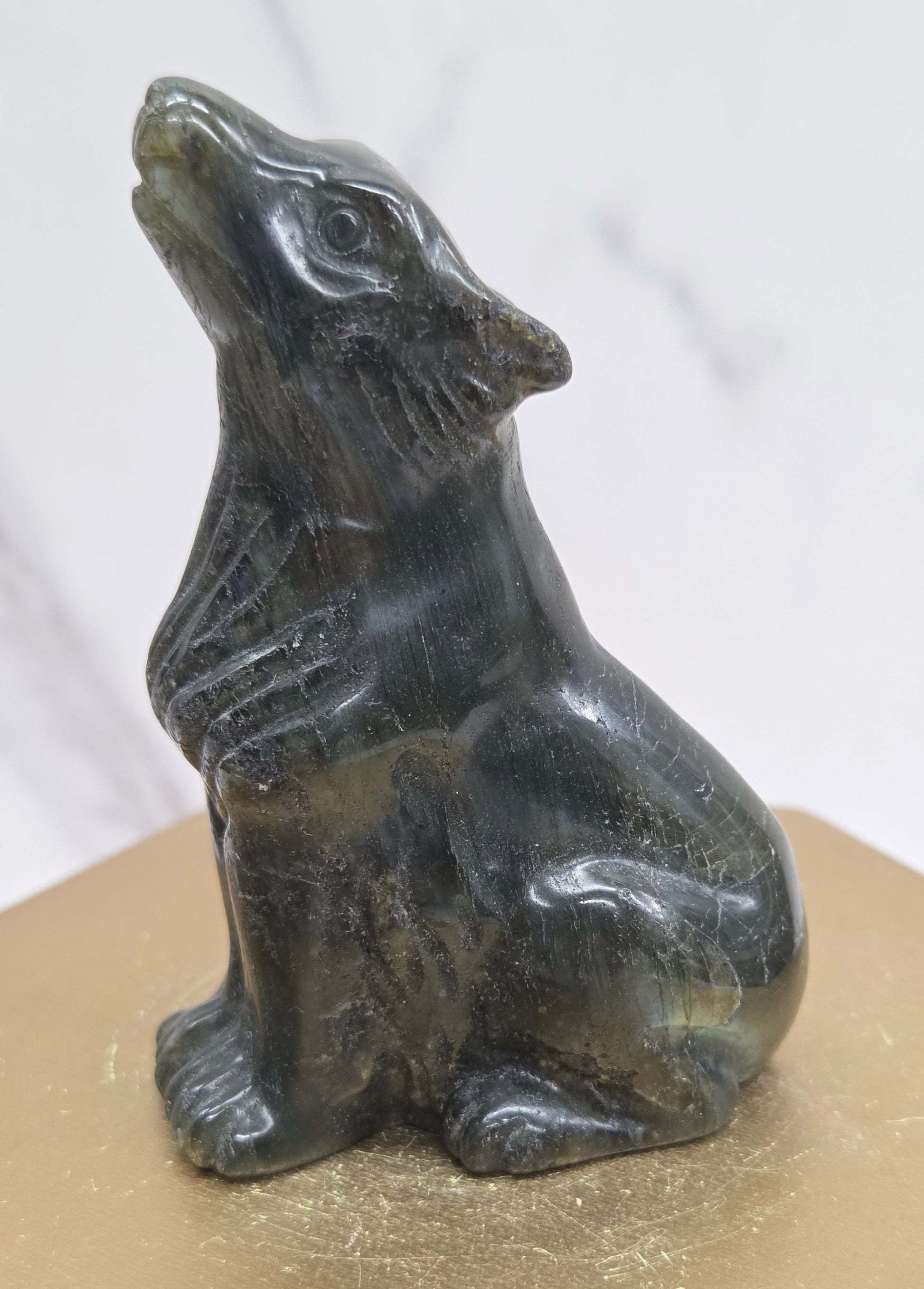 Labradorite wolf carving on a neutral background