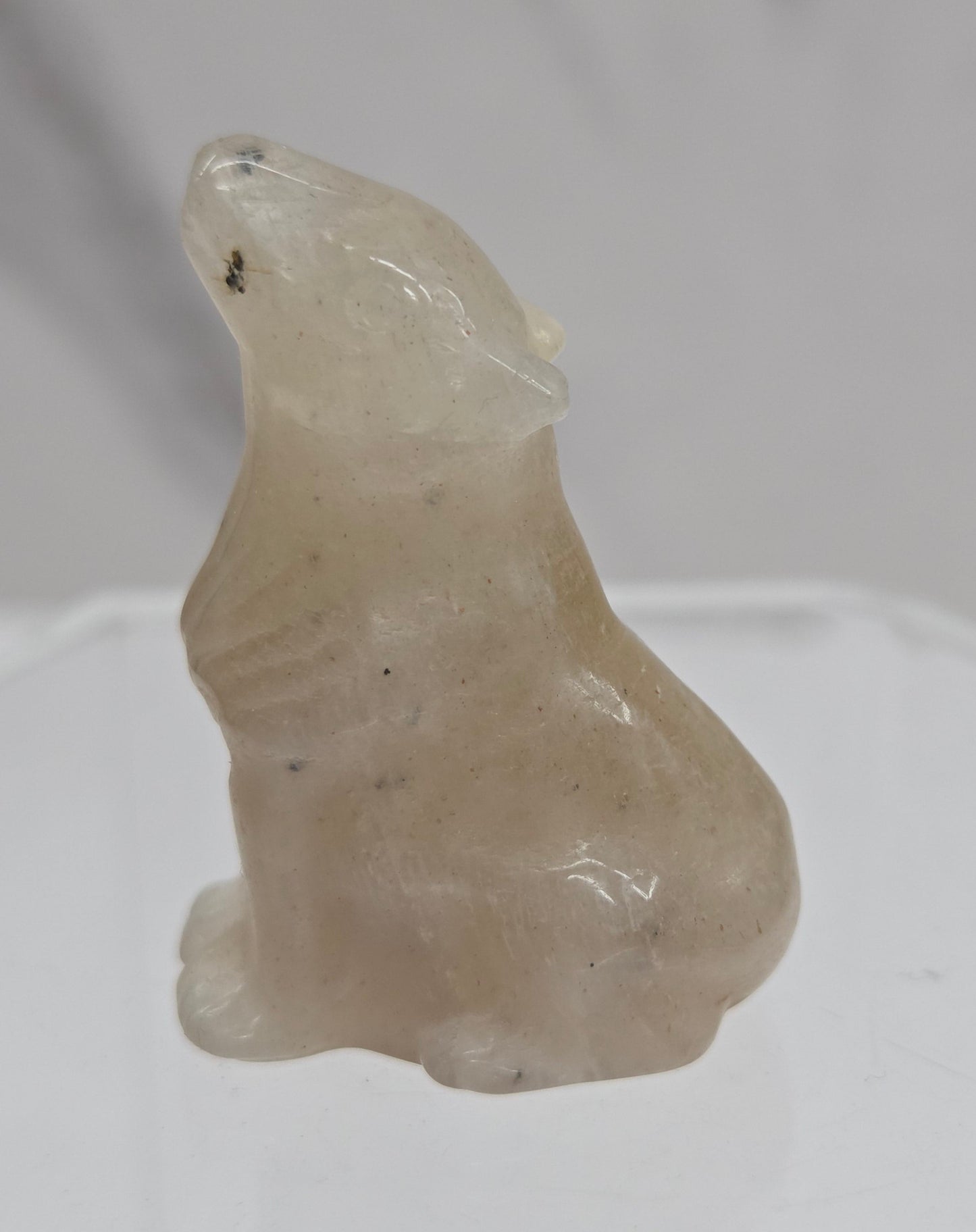 Small Moonstone crystal wolf carving  on a white background