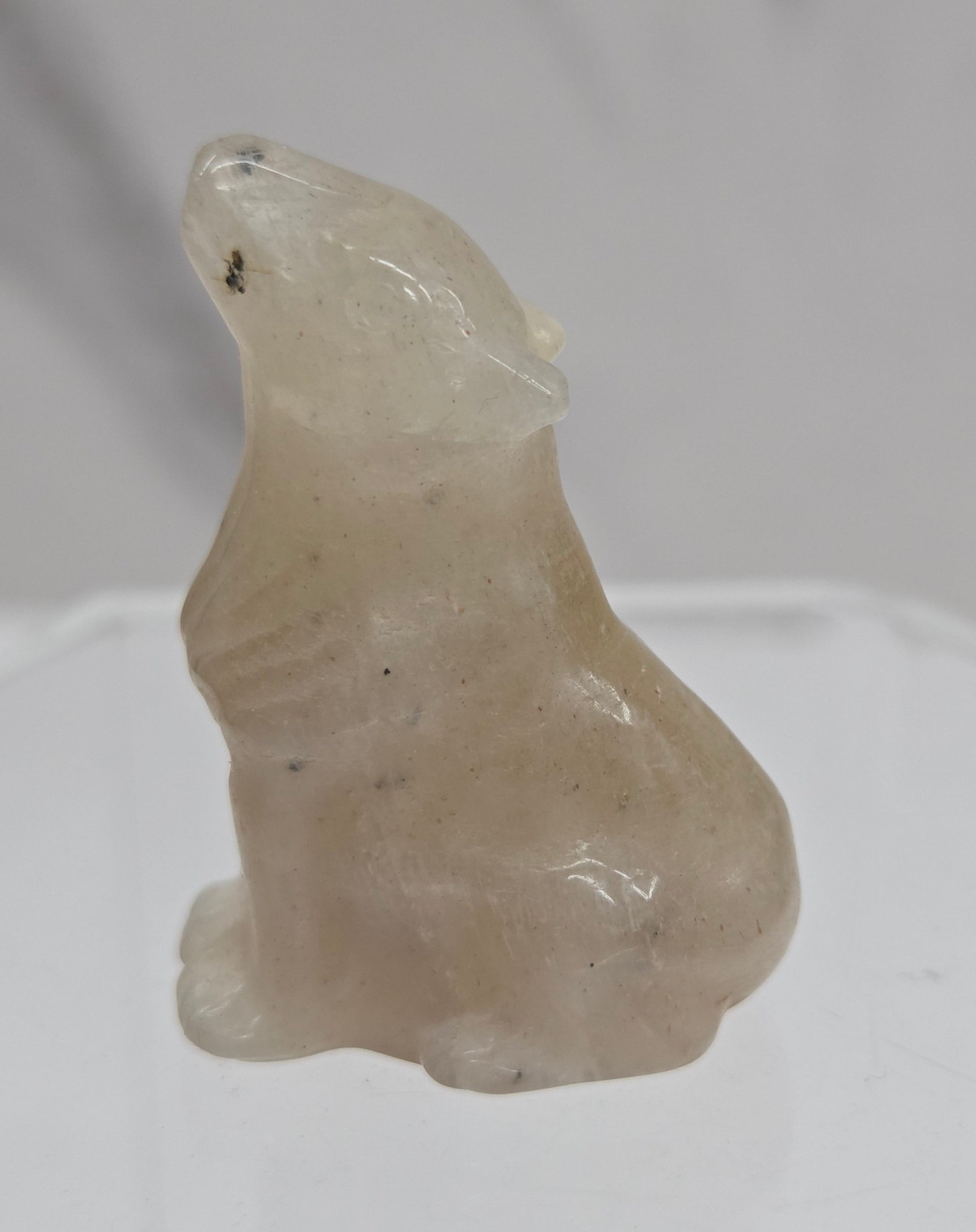 Small Moonstone crystal wolf carving  on a white background