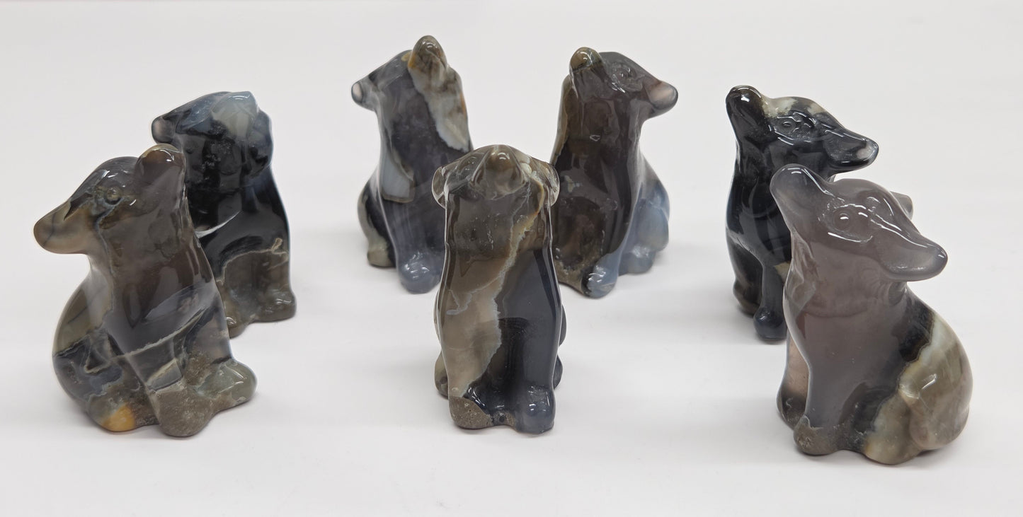 Set of Volcano Agate wolf figurines on a white background