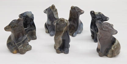Set of Volcano Agate wolf figurines on a white background