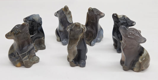 Set of Volcano Agate wolf figurines on a white background