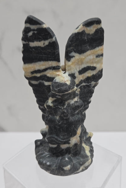 Zebra Jasper praying angel carving on an acrylic stand on a white background