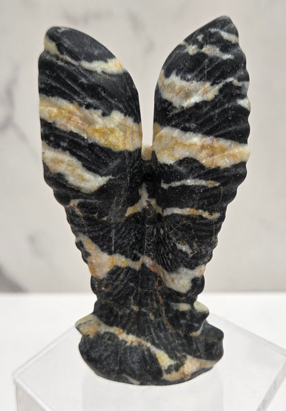 Zebra Jasper praying angel carving on an acrylic stand on a white background