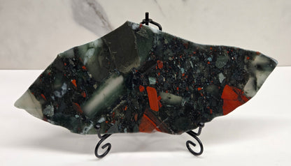 Dark stone African Bloodstone slab with red and gray patterns on a white surface.