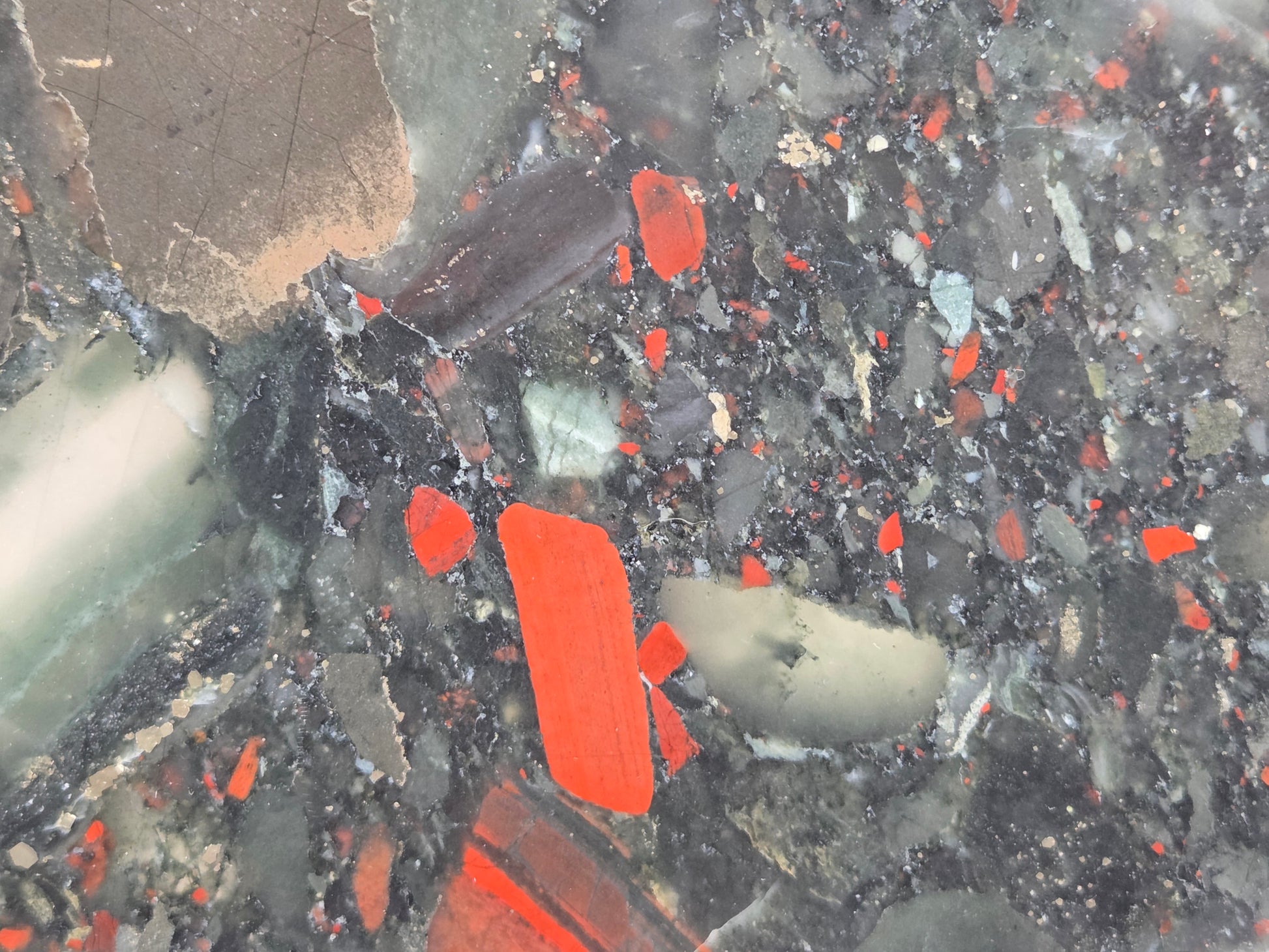Close-up of a dark stone African Bloodstone slab with red and gray patterns 