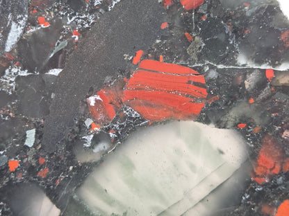 Close-up of a dark stone African Bloodstone slab with red and gray patterns