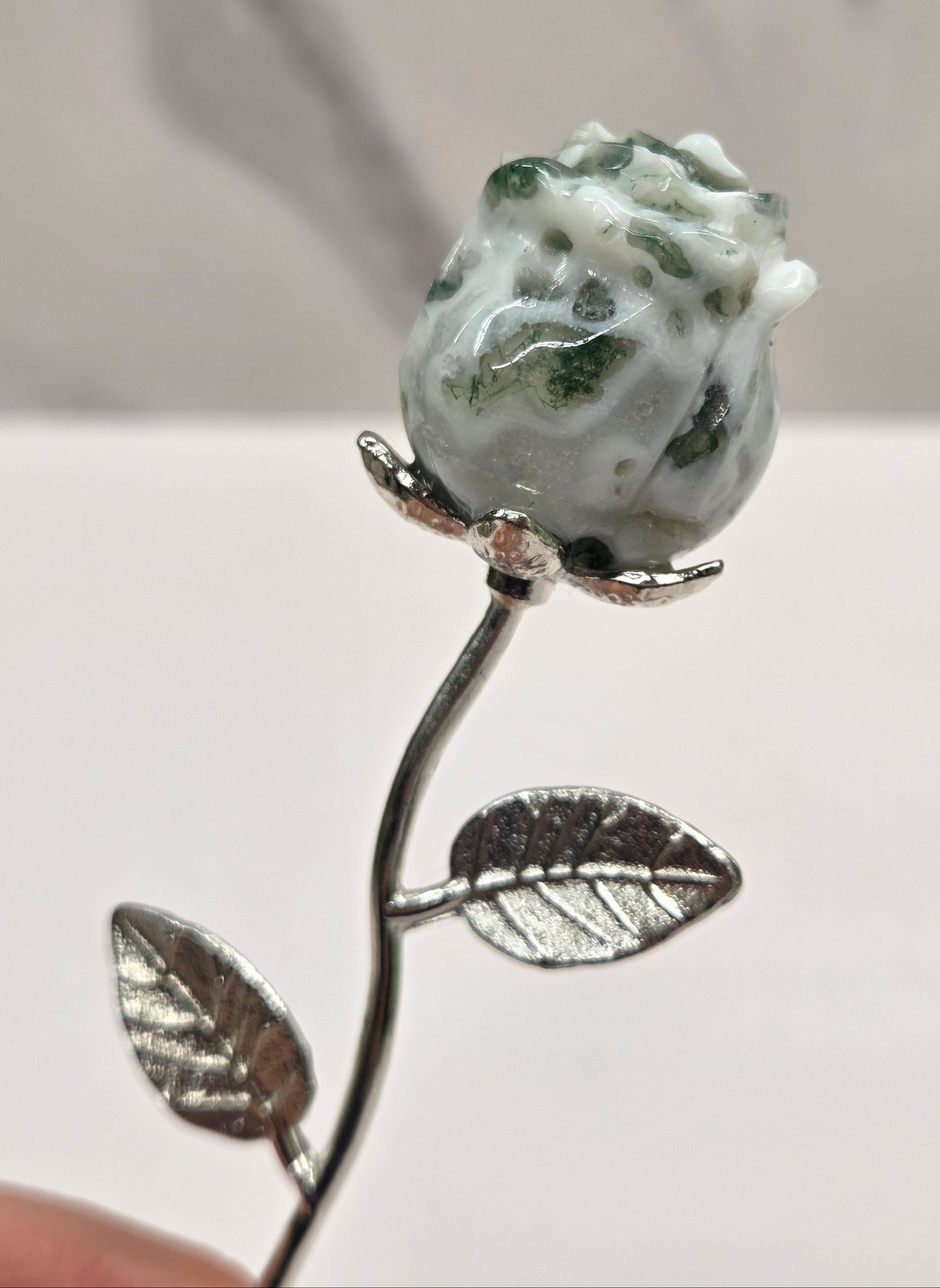 Moss Agate crystal rose mounted on silver stem.
