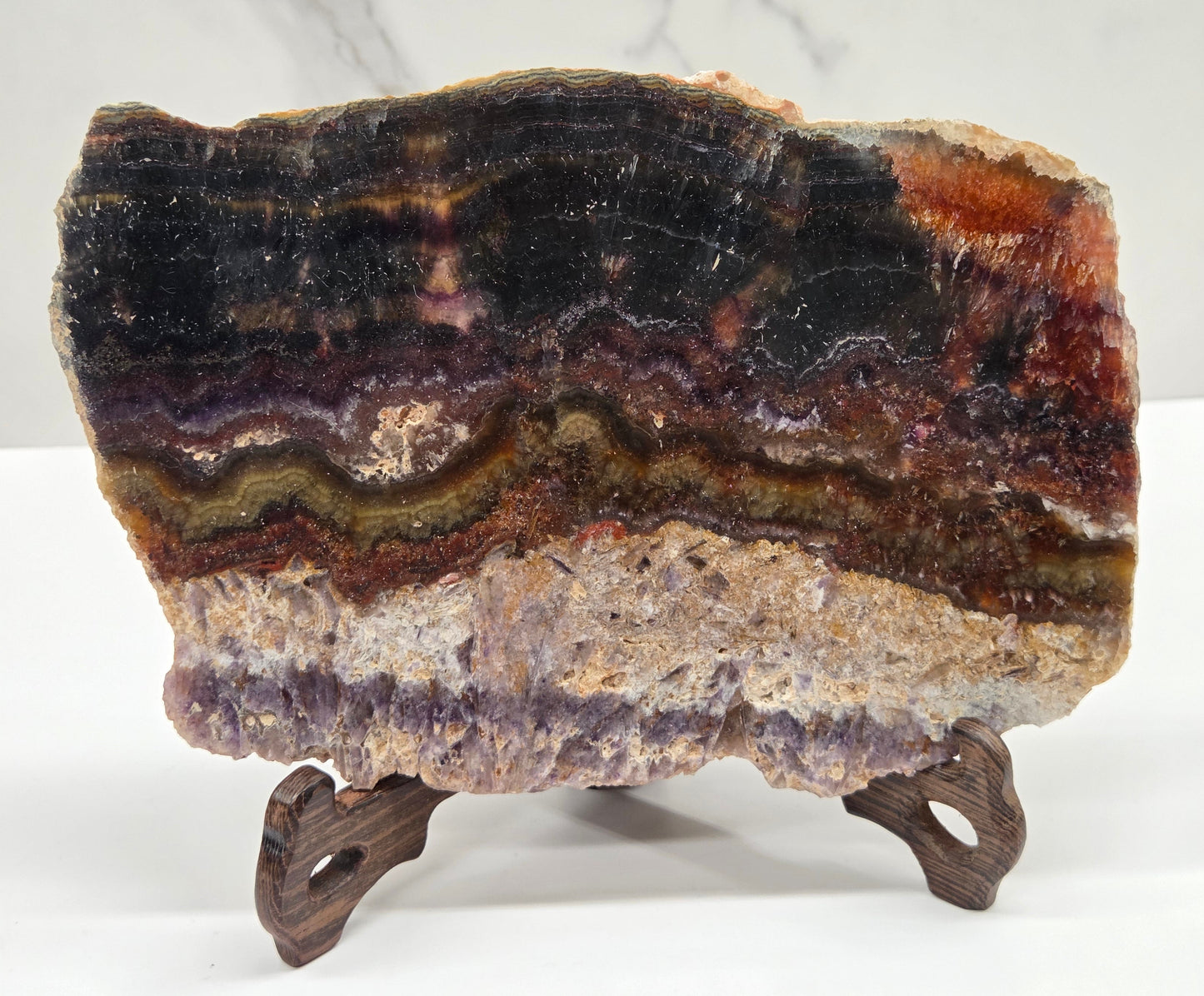 Mineral sample on a stand with a marble background