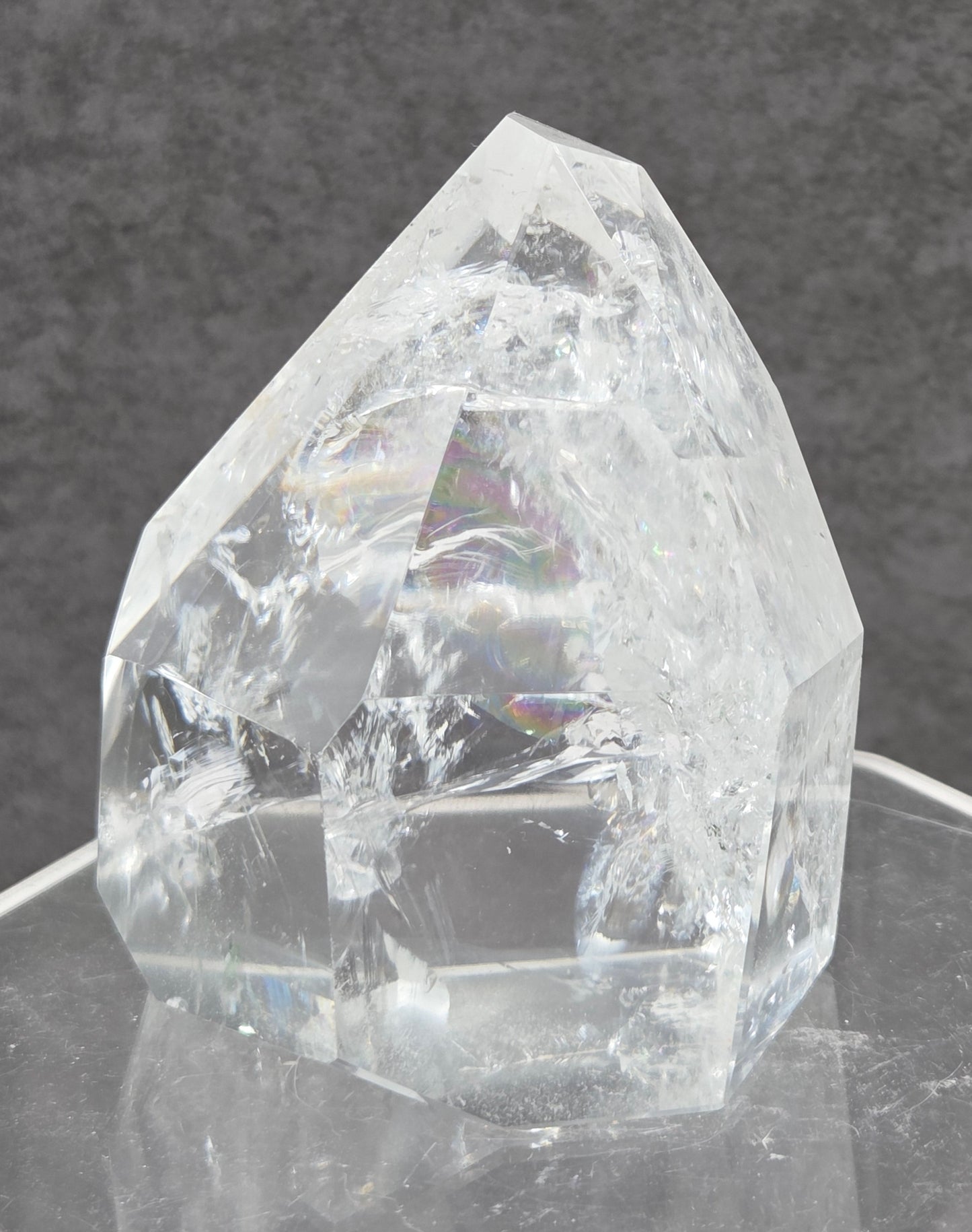 Clear Quartz tower crystal on a dark gray background