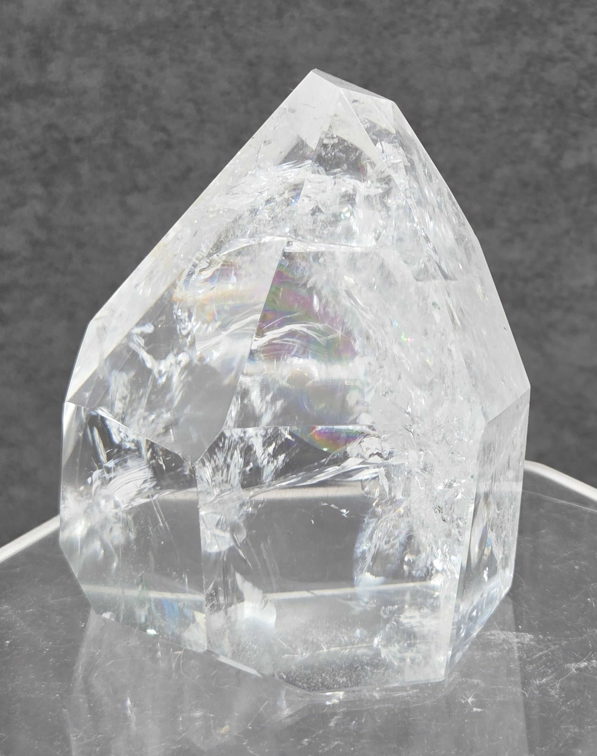 Clear Quartz tower crystal on a dark gray background