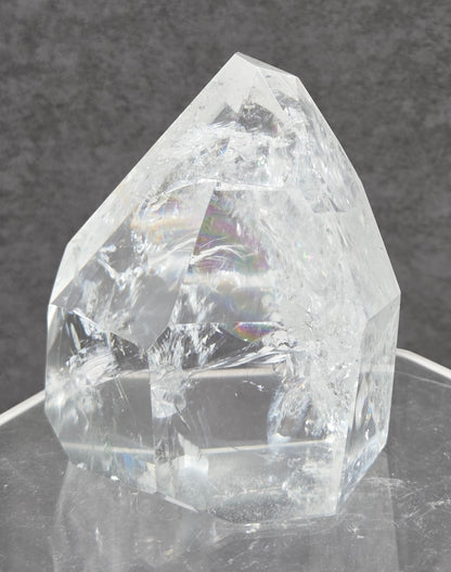 Clear Quartz tower crystal on a dark gray background