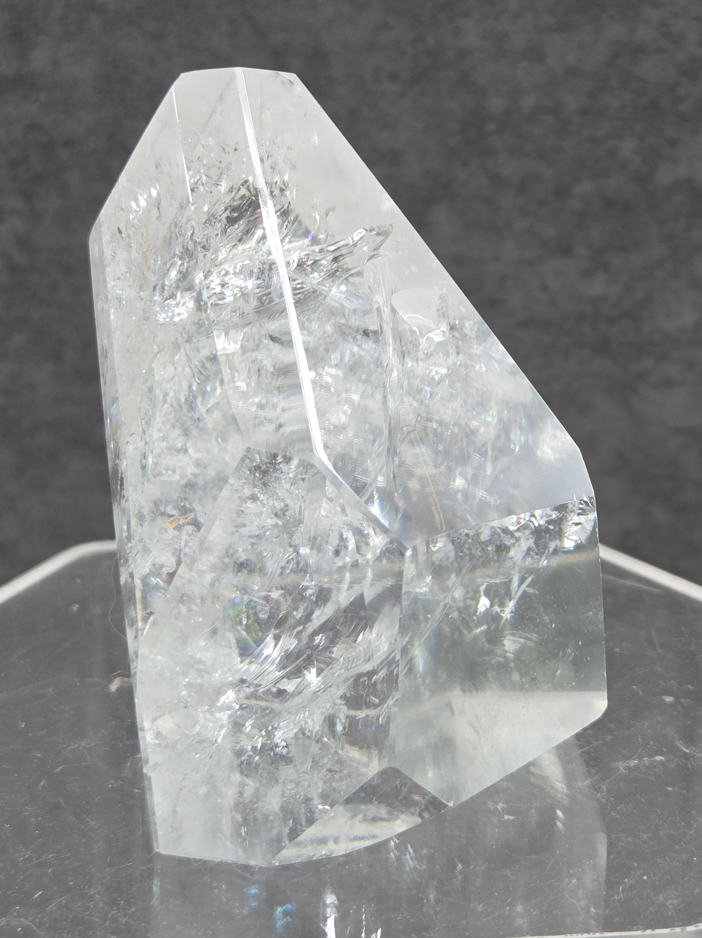 Clear Quartz tower crystal on a dark gray background