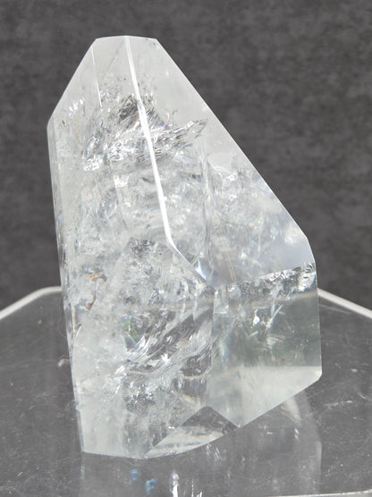 Clear Quartz tower crystal on a dark gray background