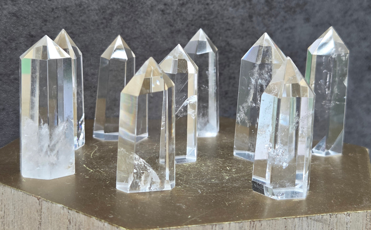 Set of crystal points on a wooden surface with a dark background