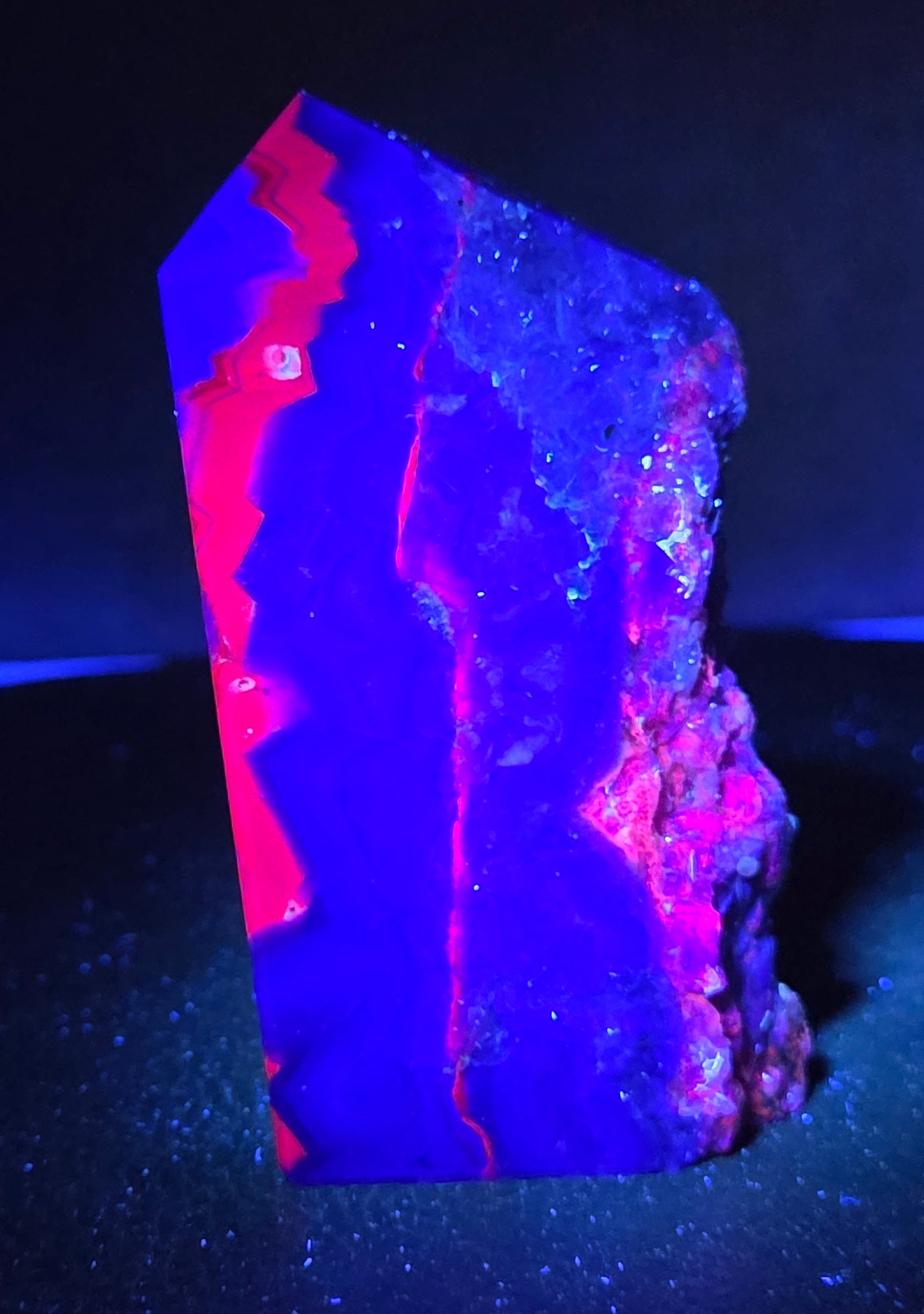 Fluorite tower under UV light on a dark surface