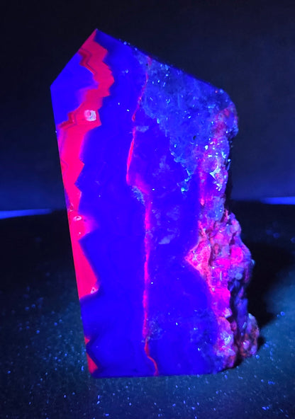 Fluorite tower under UV light on a dark surface