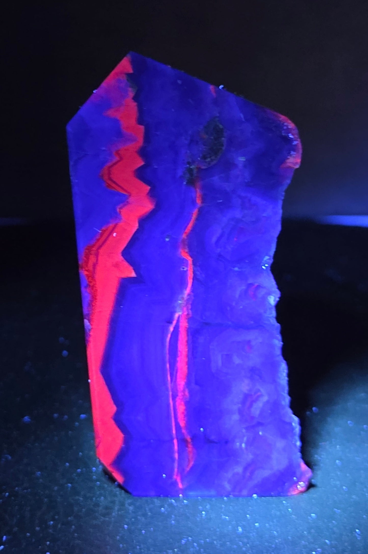 Fluorite tower under UV light on a dark surface