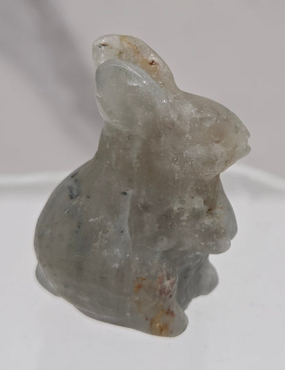 Small rabbit garden quartz crystal carving on a white background