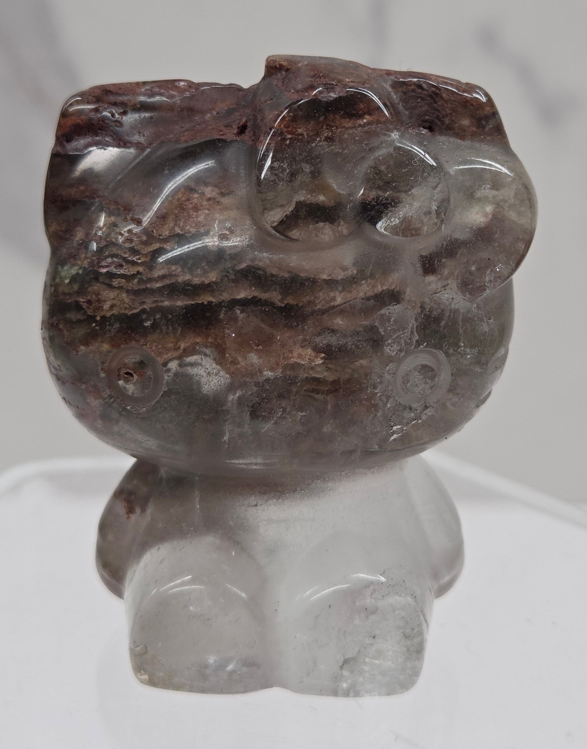 Hello Kitty garden quartz crystal carving on a white background