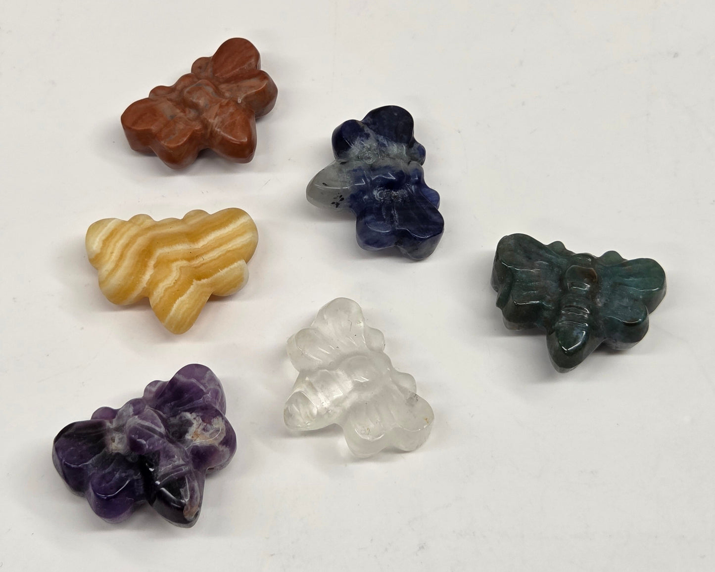 Collection of various crystal butterfly carvings on a white background