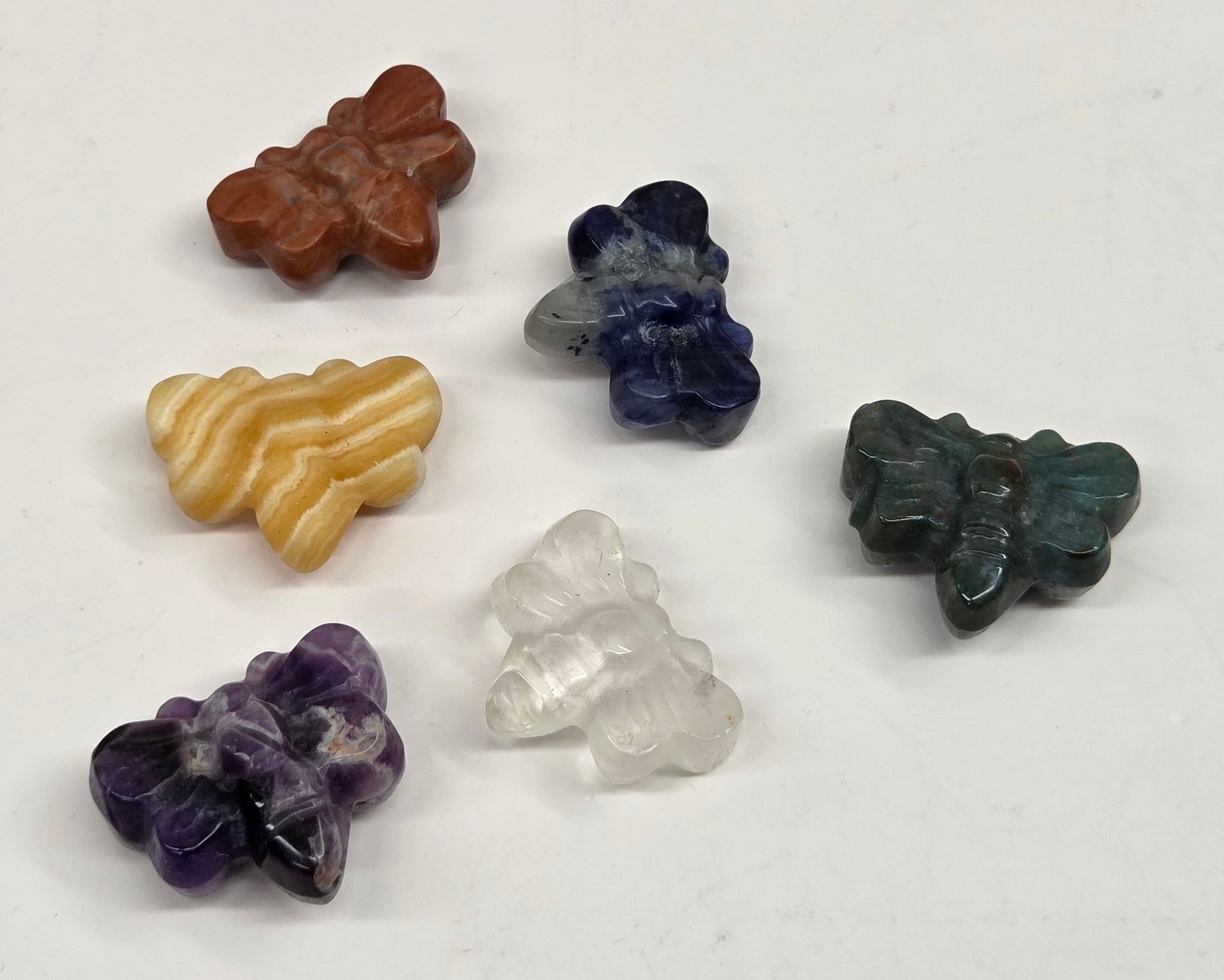 Collection of various crystal butterfly carvings on a white background