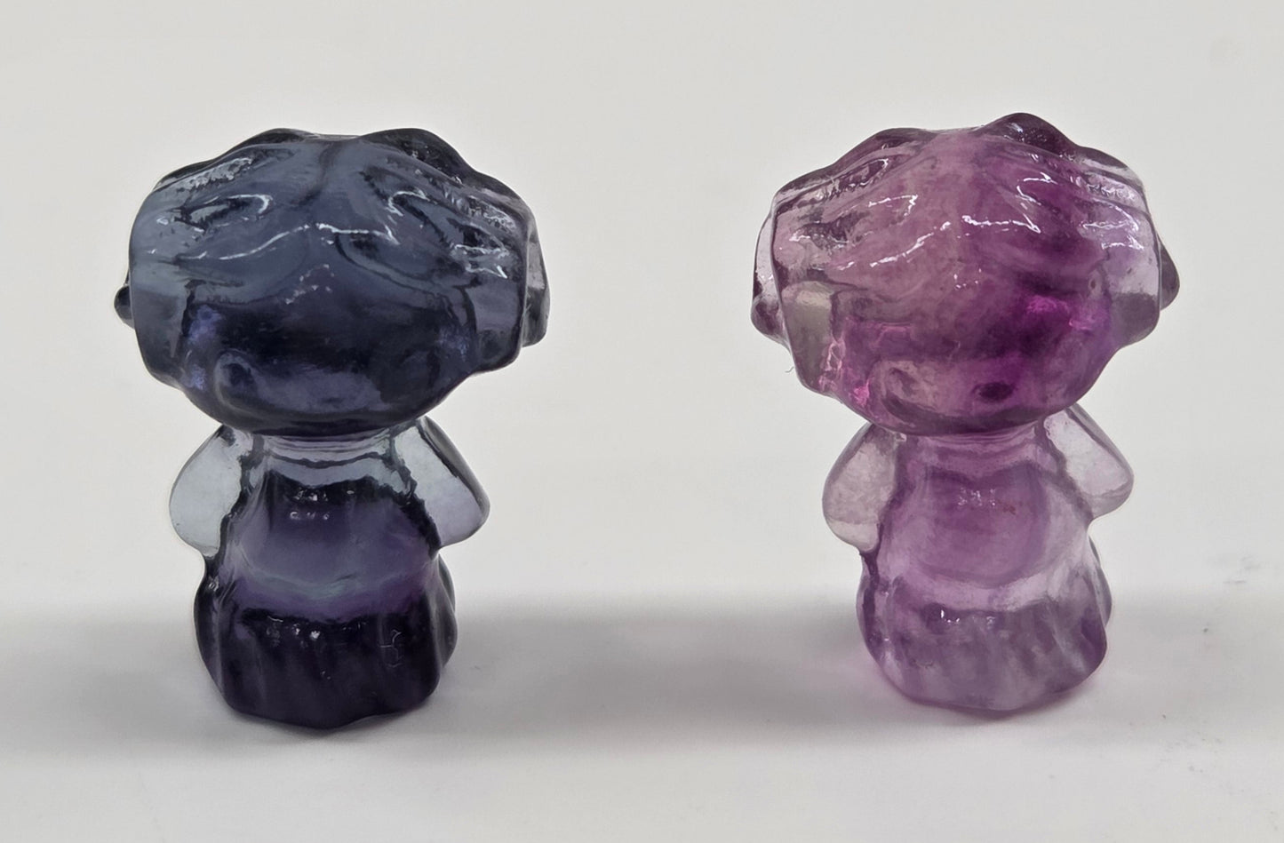 Two mini fluorite crystal figurines of Princess Leia on a white background