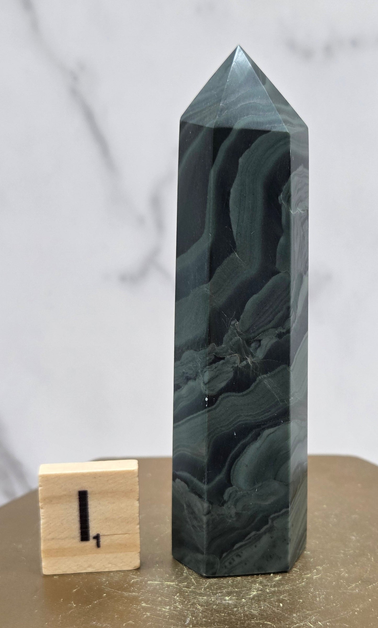 Green wave picture jasper tower on a wood base on a white background