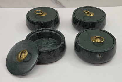 Set of 4 round bowl containers, each  with a gold colored handle on the lid,  made of green wave picture jasper, with wave like patterns, on a white background