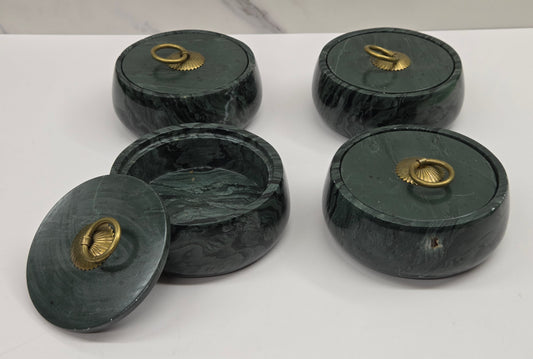 Set of 4 round bowl containers, each  with a gold colored handle on the lid,  made of green wave picture jasper, with wave like patterns, on a white background