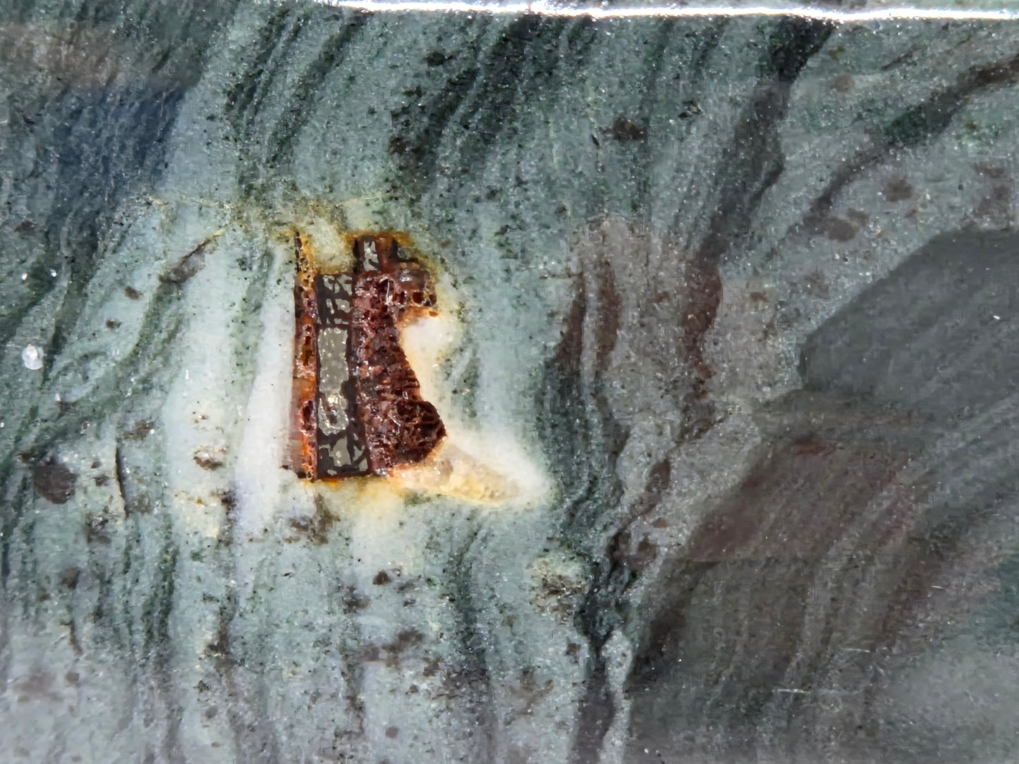 Close-up of green wave picture jasper with wave like patterns and a pyrite inclusion