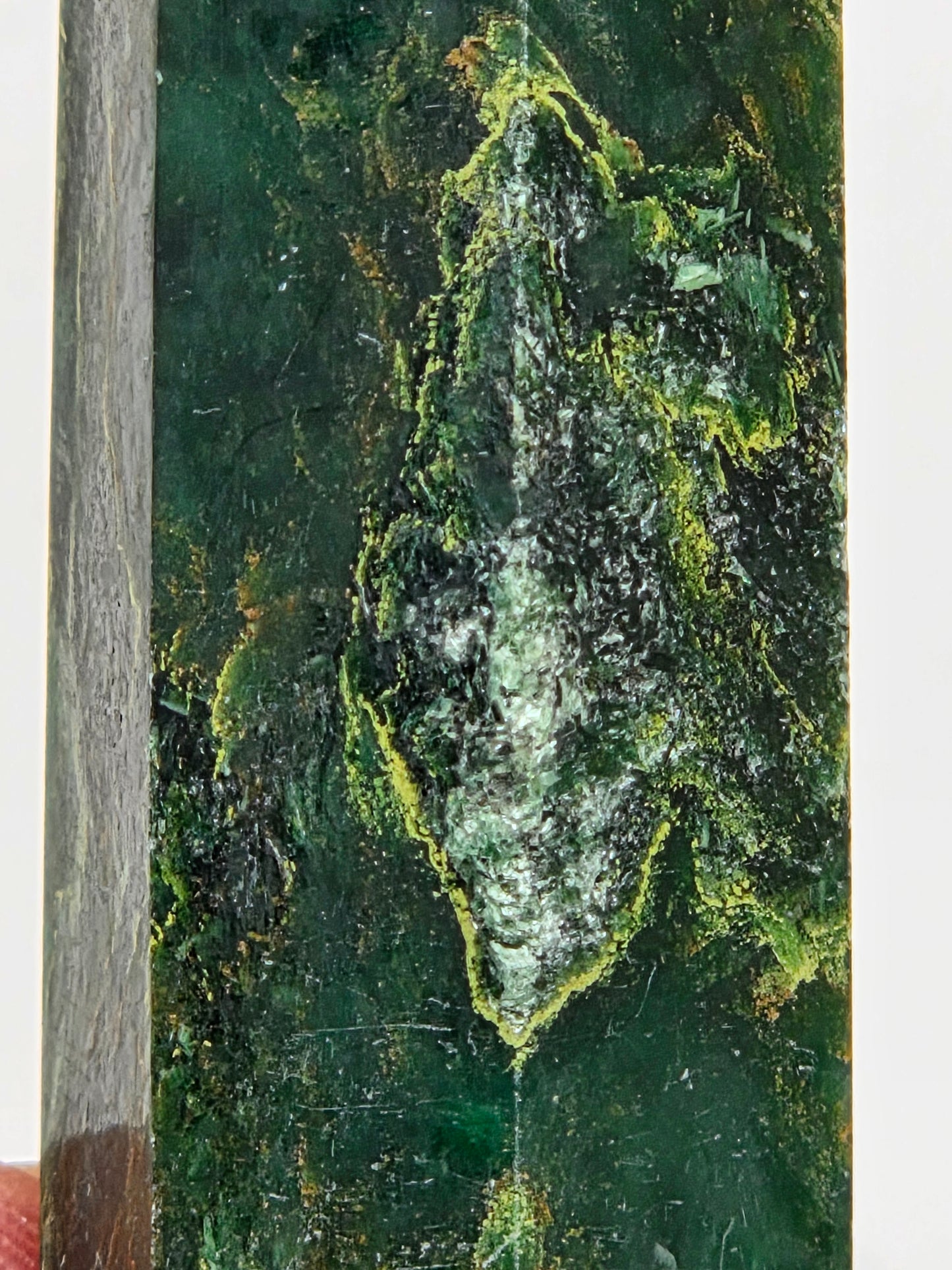 Close-up of an emerald tower with yellow and black inclusions