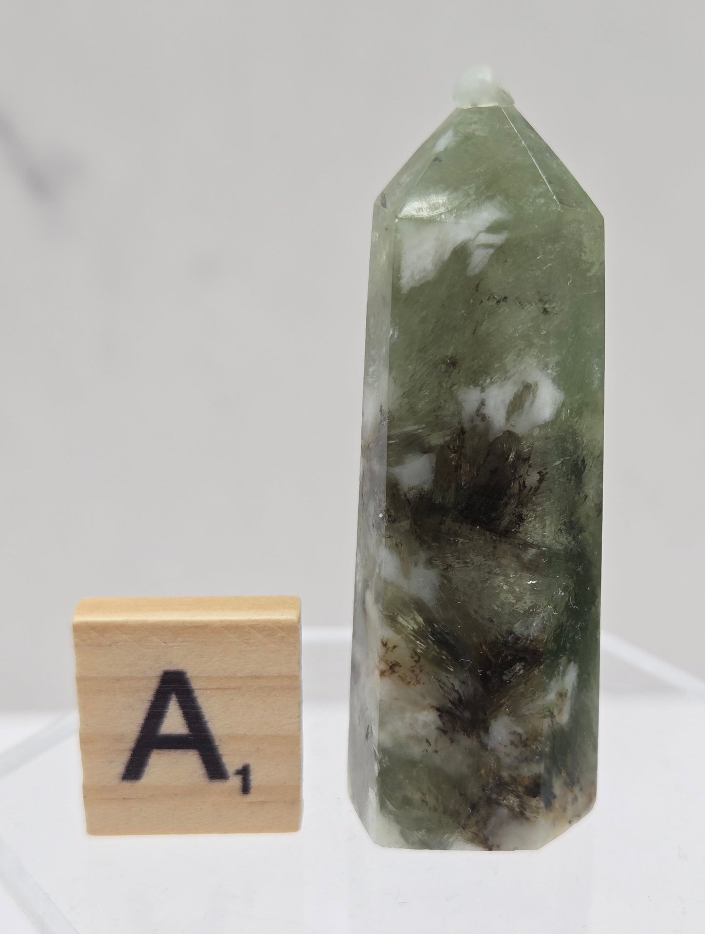 Green crystal tower with a wooden block labeled 'A' on a white background