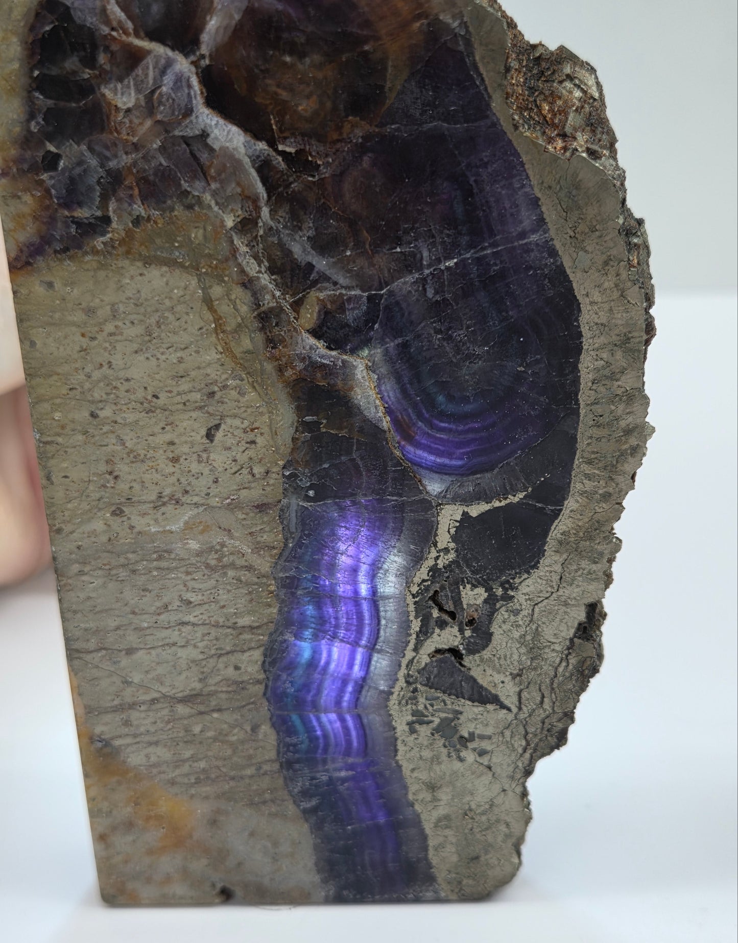 Mineral sample with purple and blue fluorite on a white background