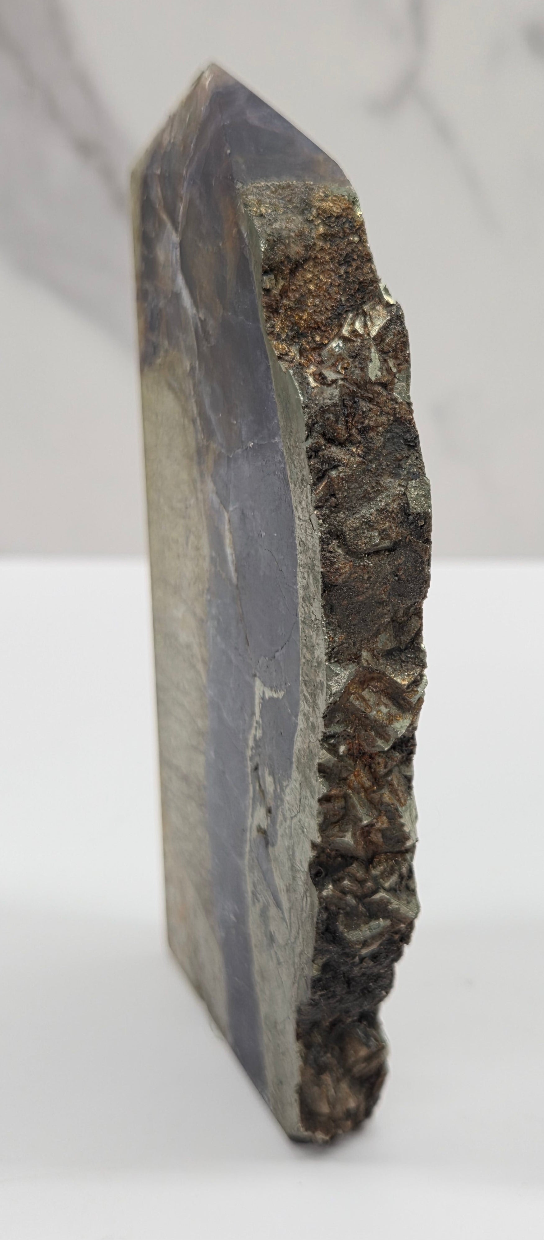 Geological sample with layered rock on a white background