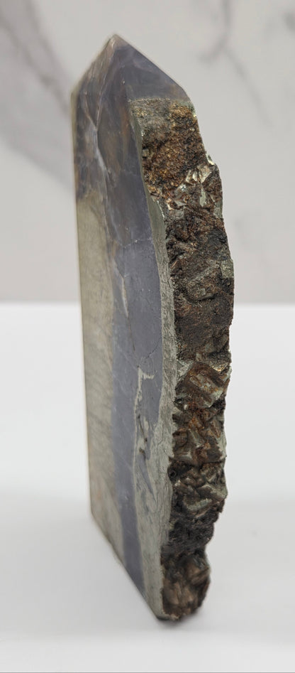 Geological sample with layered rock on a white background
