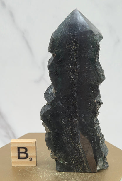 Fluorite crystal on a wooden stand with a marble background