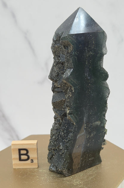 Fluorite crystal on a wooden stand with a marble background