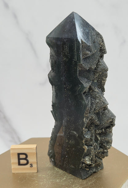 Fluorite crystal on a wooden stand with a marble background