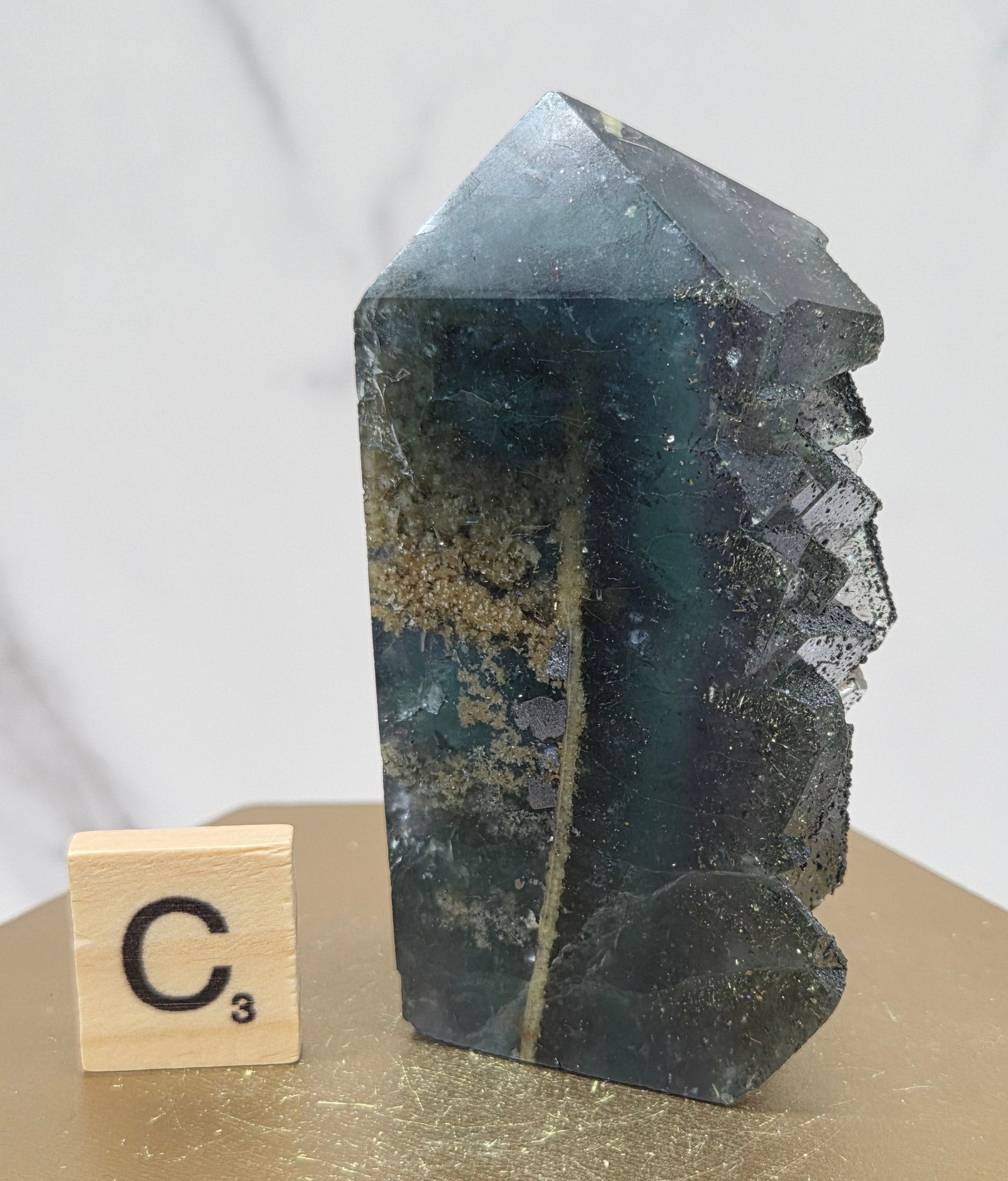 Fluorite crystal on a wooden stand with a marble background