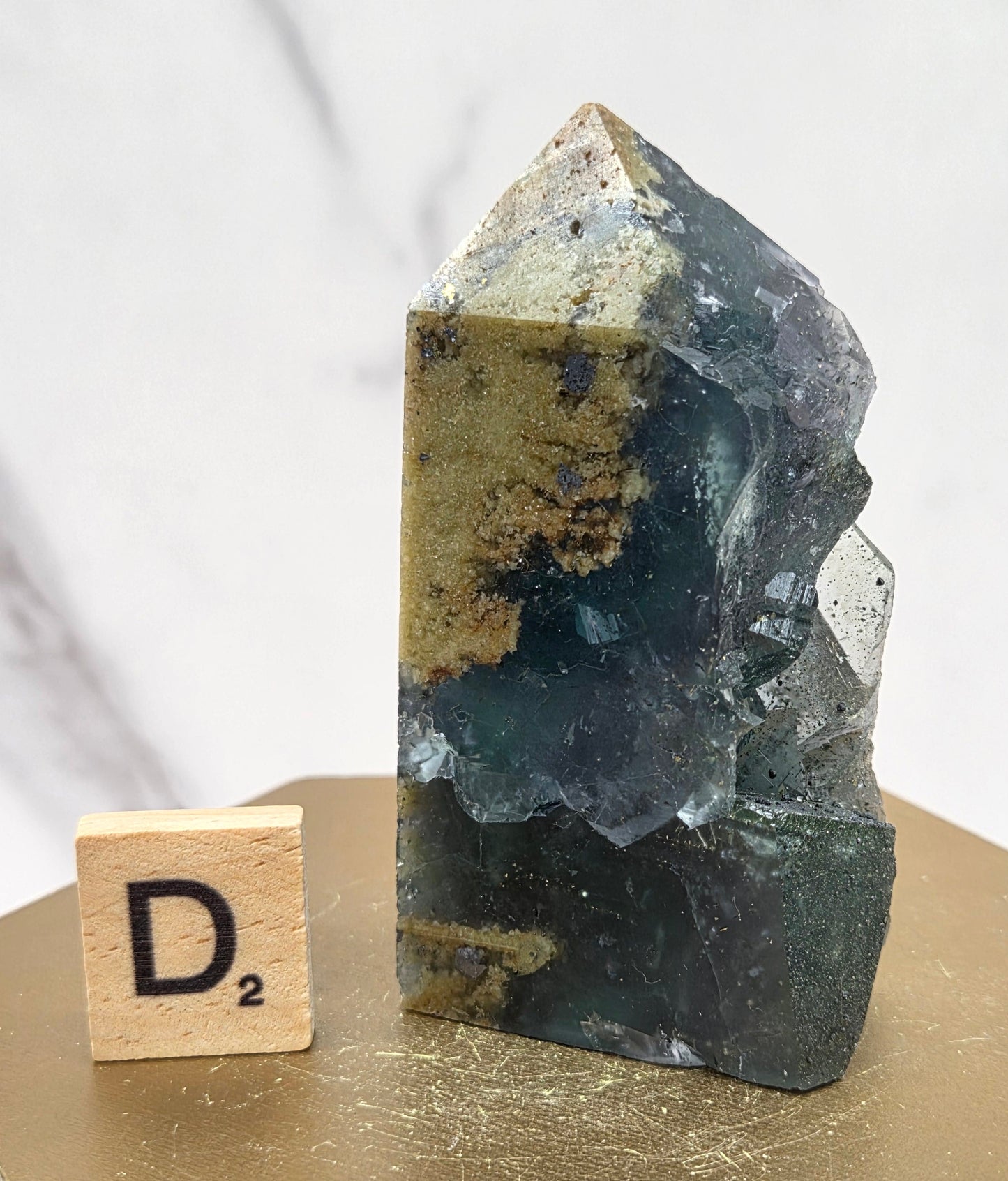 Fluorite crystal on a wooden stand with a marble background