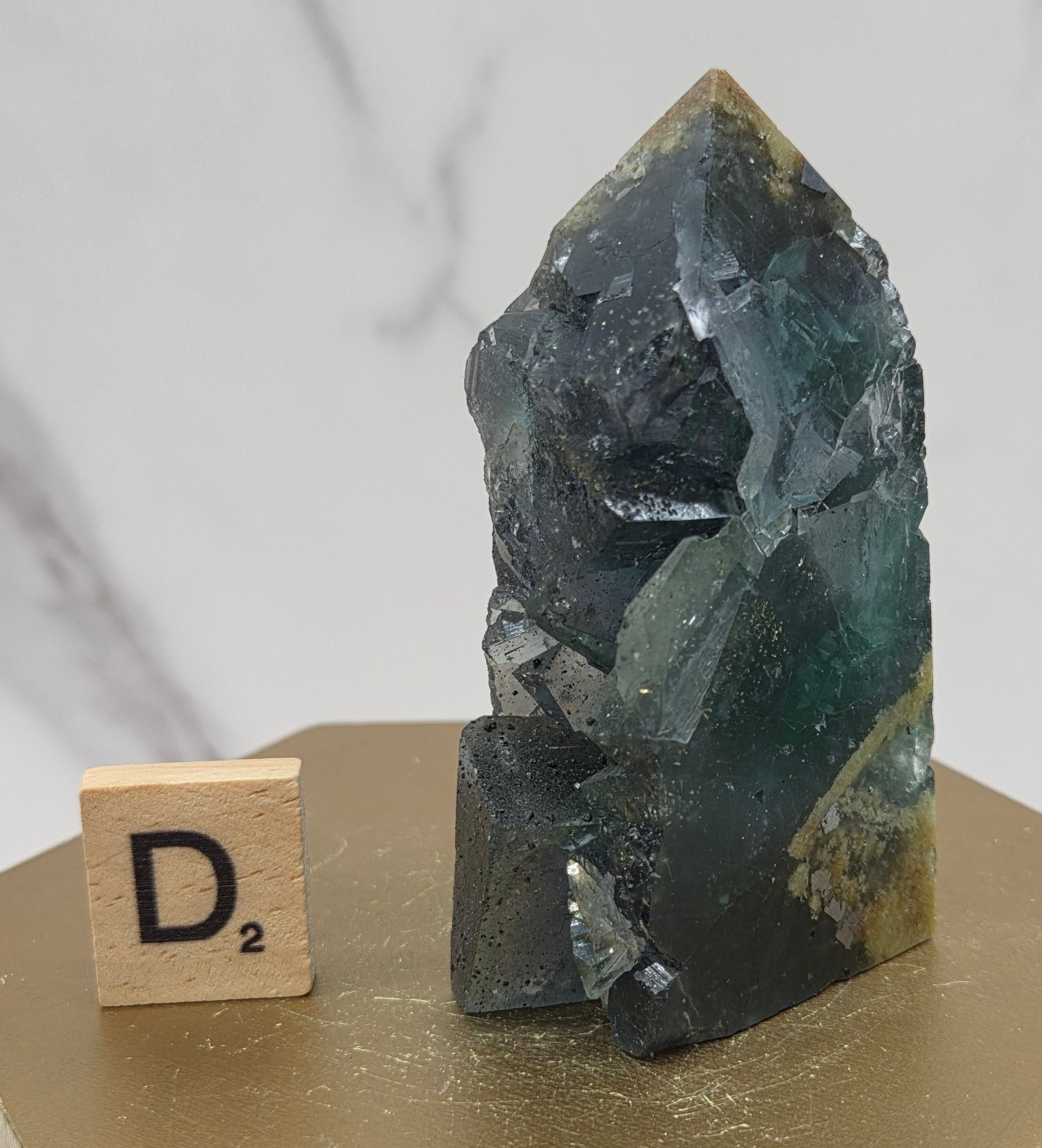 Fluorite crystal on a wooden stand with a marble background